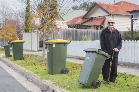 Older resident with rubbish bin