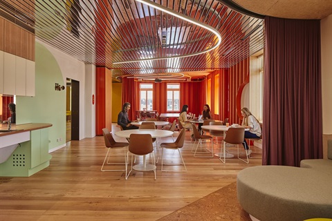 People sitting at different tables in the intercultural centre lounge.jpg