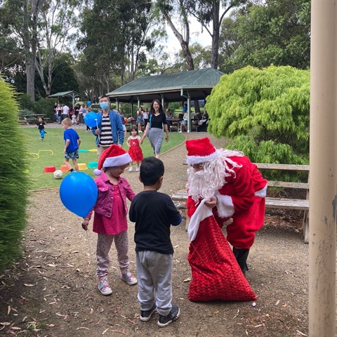 santa talking to children at the golf course