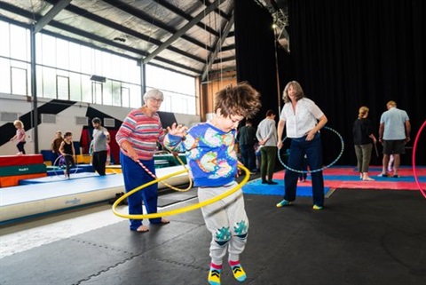 child using a hula hoop circus nexus