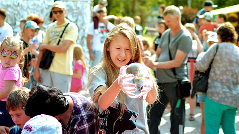 Girl with a giant bubble at a festival