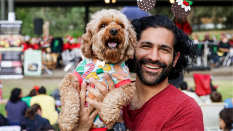 Person holding dog at Christmas