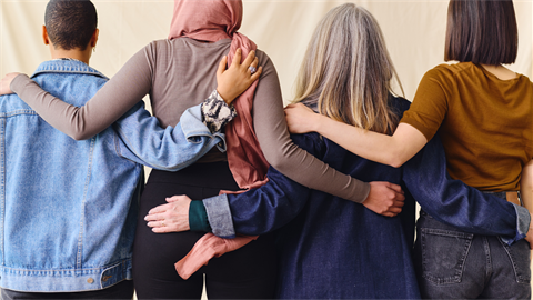 Women standing arm in arm tile.png