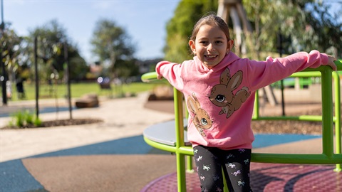 Young girl on playing on a playground in Penders Park