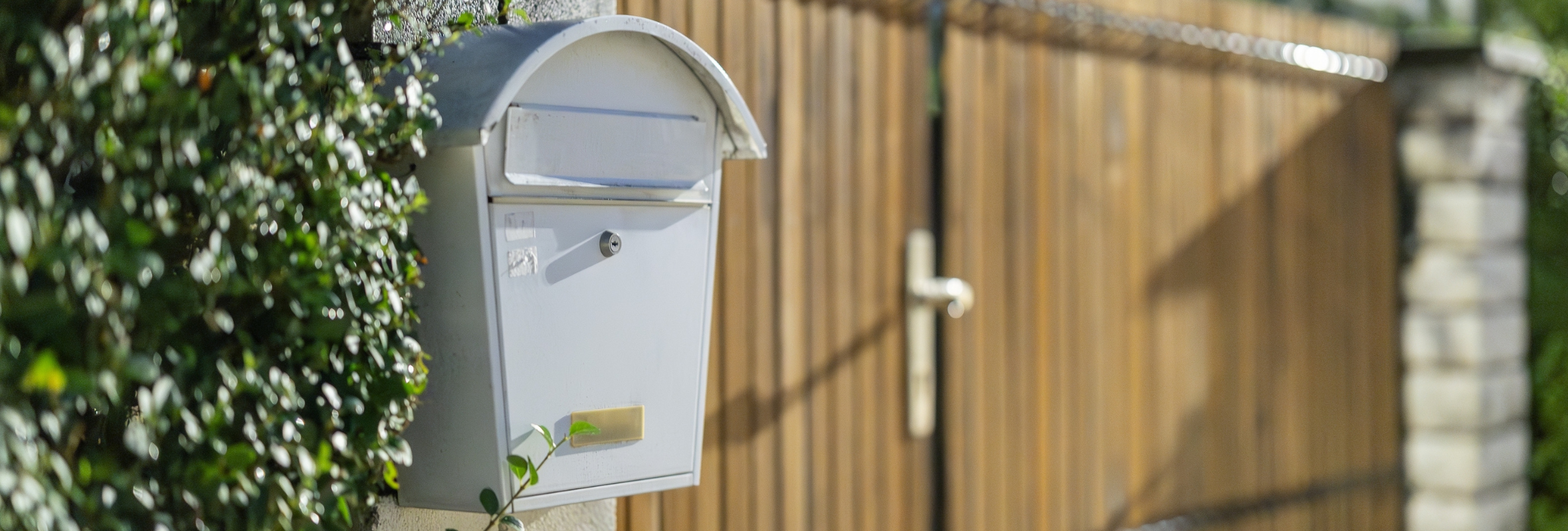 Banner letter box postal post and fence.png