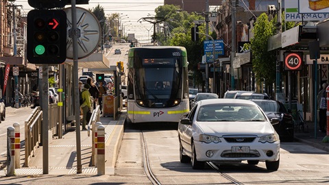 Tram and cars on a busy Darebin road