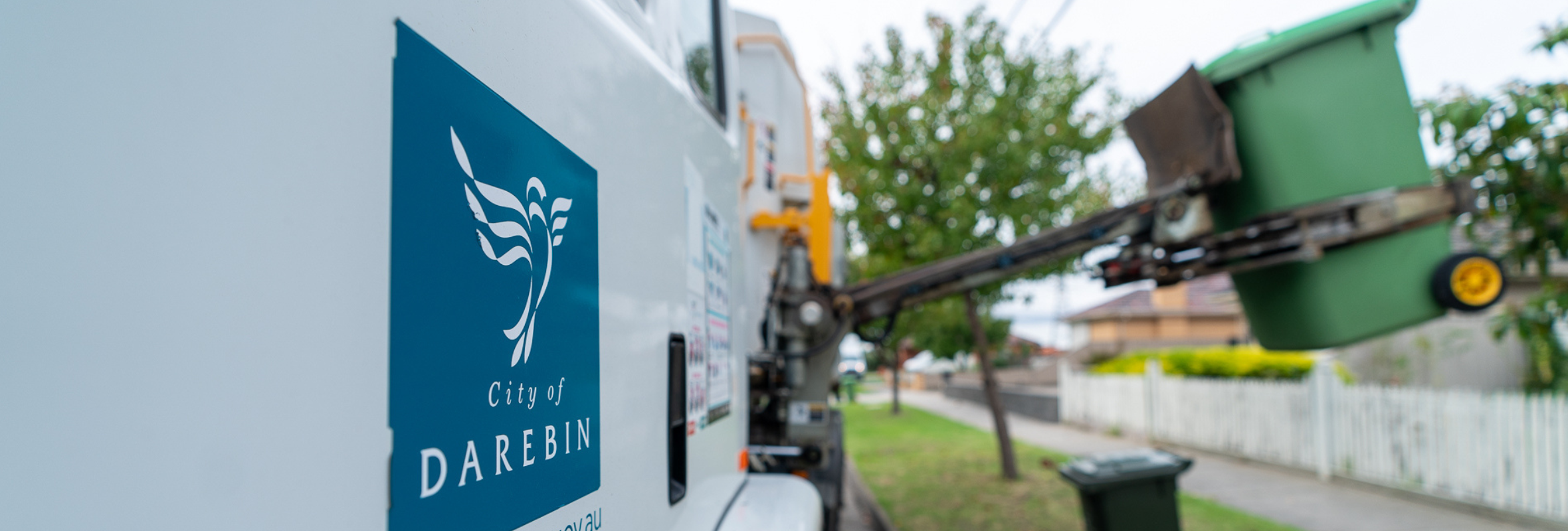 Close up of a rubbish truck picking up a wheelie bin